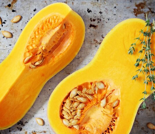 Roasted Butternut Squash With Ricotta Salata A ripe yellow butternut squash cut in half revealing the meat and seeds