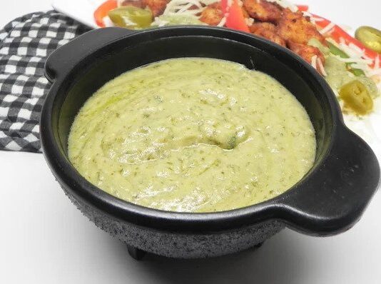 Avocado Cream Sauce Black bowl filled with creamy avocado sauce