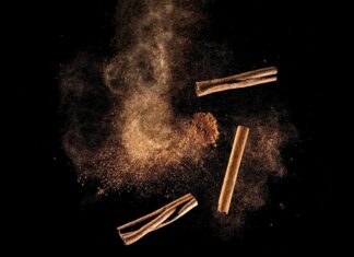 Cinnamon: People Love It but Health Benefits Remain Sketchy Artist's rendition of cinnamon powder and sticks airborne against a black background