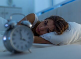 Can’t Sleep A distraught woman in bed wide awake at four in the morning