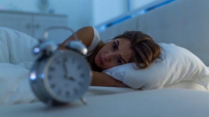 Medicinal Plants for Sleep A distraught woman in bed wide awake at four in the morning