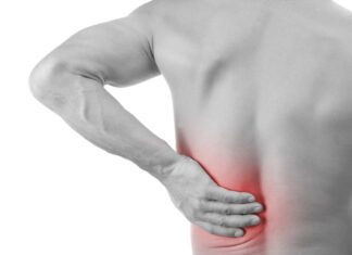 Muscle Pain Man with back pain grabbing his lower back