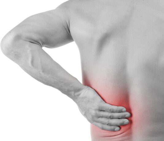 Muscle Pain Man with back pain grabbing his lower back