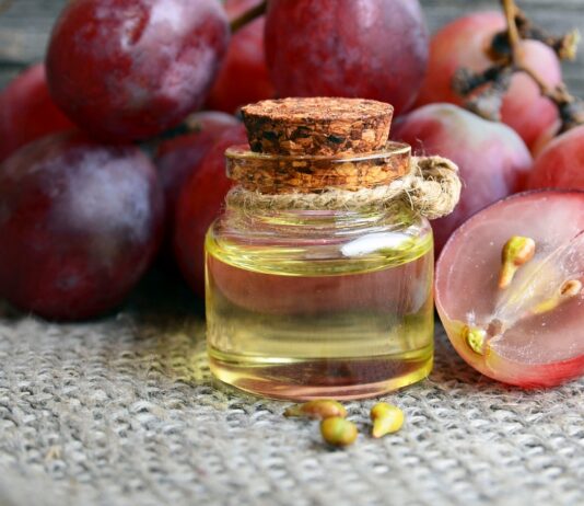 Grape Seed Extract: Here’s Why You Need to Know About It Tincture of grape oil with red grapes in the background