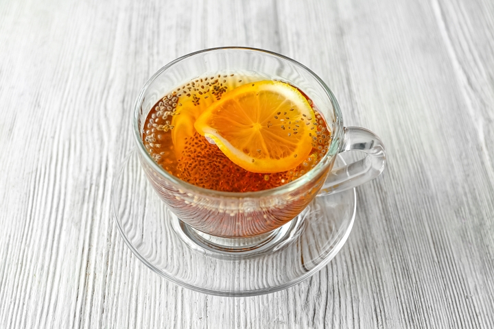 Chia tea with slice of lemon in clear glass cup